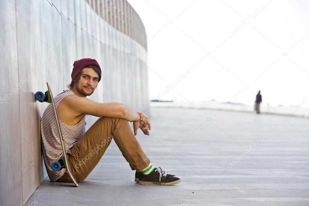 Youth sitting against the granite wall