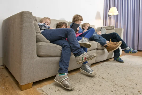 Bored children gaming on a couch — Stock Photo, Image