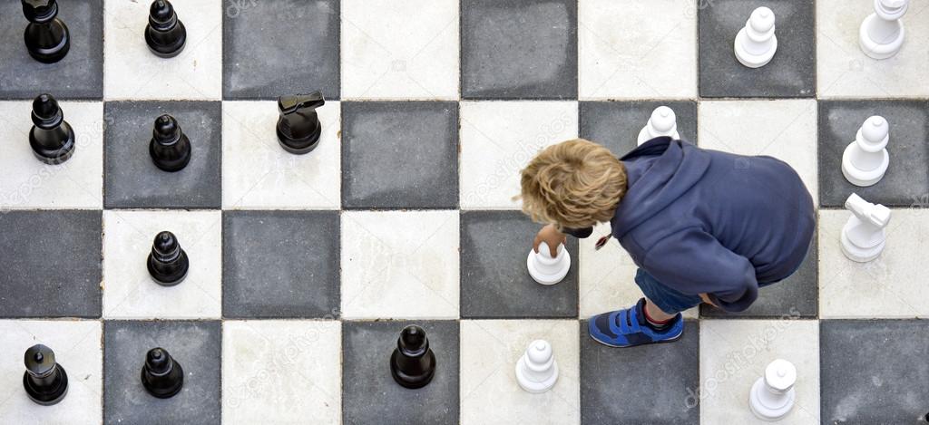 Child playing outdoor chess