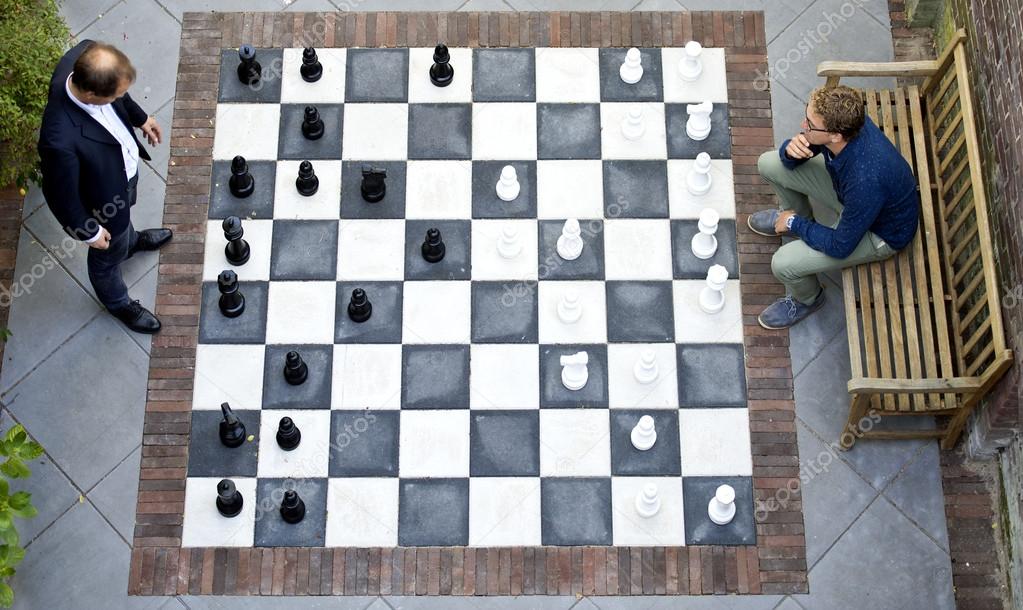 Two men playing a game of outdoor chess