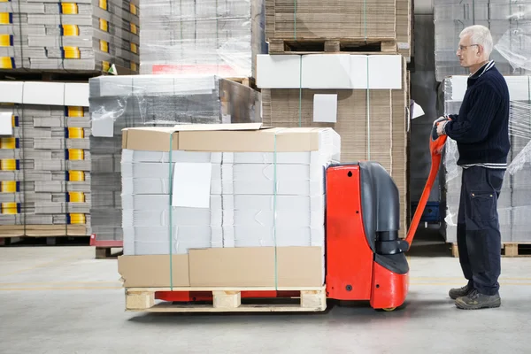 Worker With Loaded Handtruck In Warehouse — Stock Photo, Image