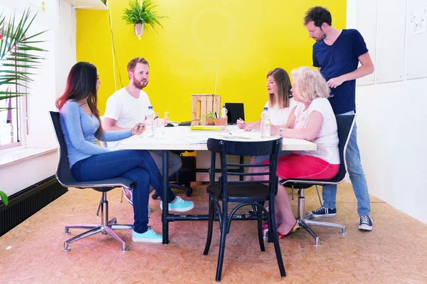 Designers sitting at a large table — Stock Photo, Image