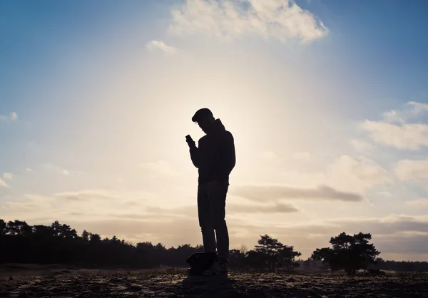 Man standing on a barren field — Stock Photo, Image