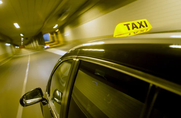 Black taxi driving through a tunnel — Stock Photo, Image