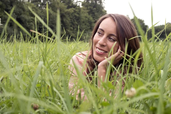 Femme couchée sur une prairie — Photo