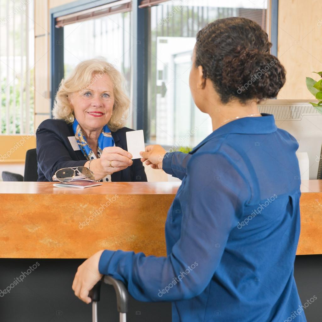receptionist giving customer a key card