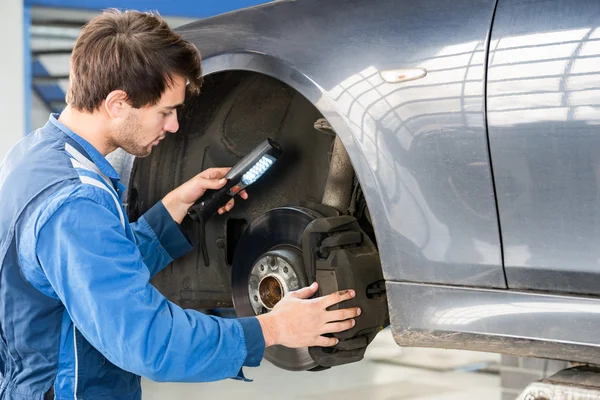 Mechanic checking brake system Stock Picture