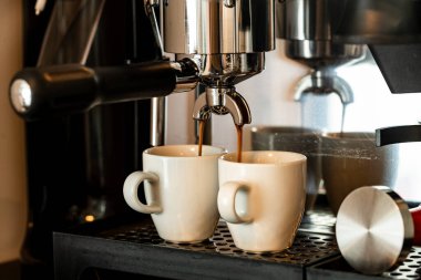 Close up image of professional espresso machine pouring in two cups