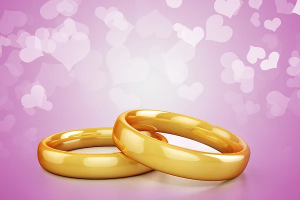 3d gold wedding rings on  hearts  background — Stock Photo, Image