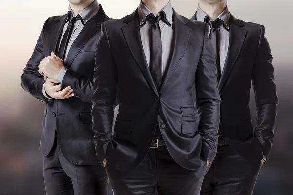 Close up image of three business men in black suit Stock Photo