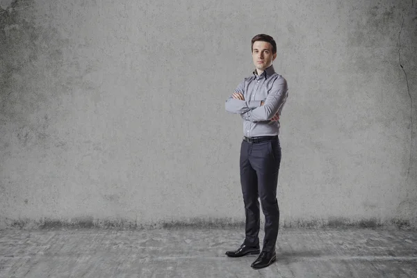 Business man  standing against vintage wall — Stock Photo, Image