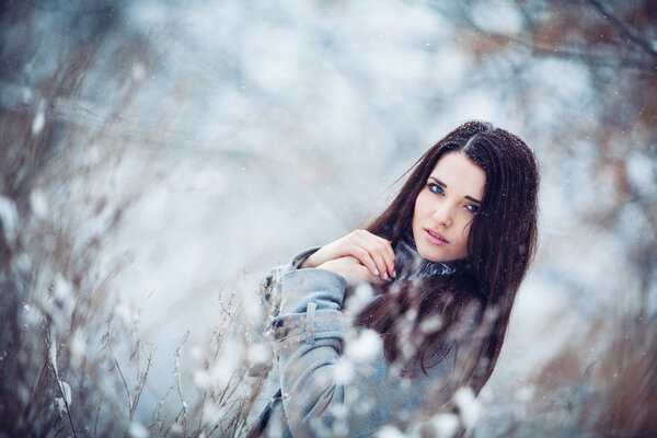 Girl in winter forest frozen