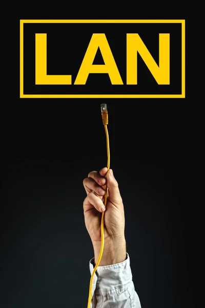 Businessman plugging LAN cable to connect to network — Stock Photo, Image