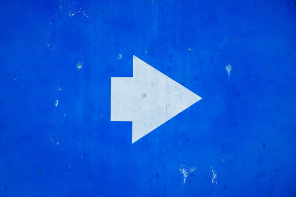 Direction sign white arrow on blue background
