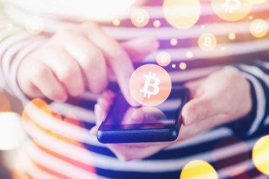 Woman paying with Bitcoins over mobile smartphone