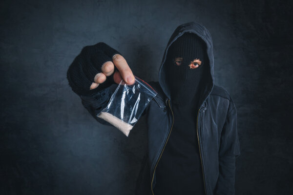 Drug dealer offering narcotic substance to addict on the street