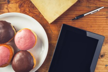 Lezzetli çörekler ve dijital tablet bilgisayar masada