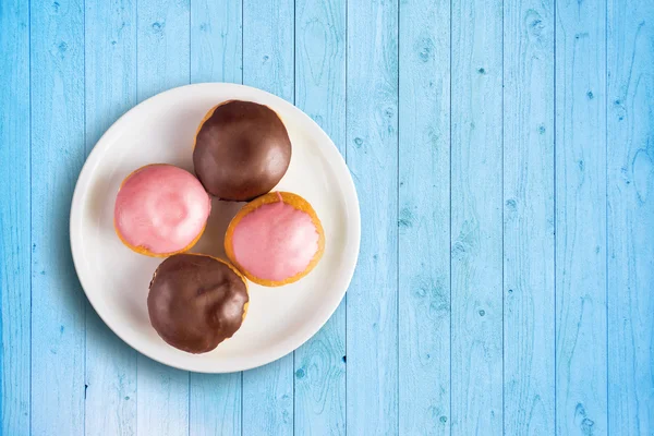 Vista superior de donuts com cobertura doce em um prato — Fotografia de Stock