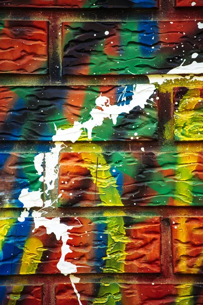 Colorful paint sprayed brick wall — Stock Photo, Image