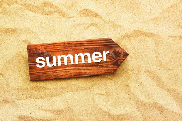 Summer direction sign in warm beach sand — Stock Photo, Image