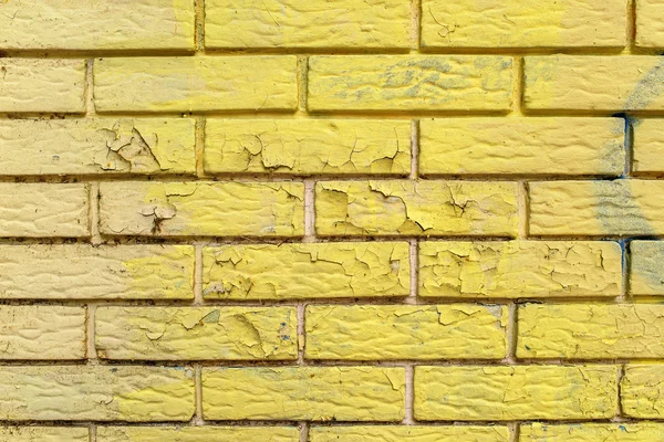 Yellow paint peeling of brick wall masonry surface — Stock Photo, Image