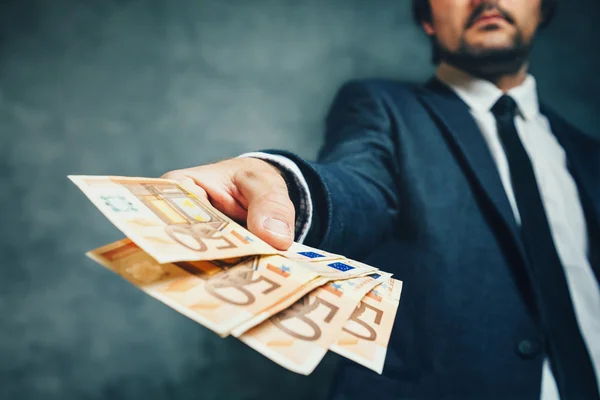 Businessman from bank offering money loan in euro banknotes — Stock Photo, Image