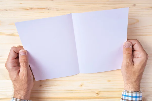 Man holding blank brochure as mock up copy space — Stock Photo, Image