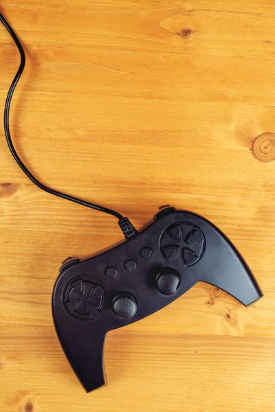 Gamepad controller on wooden desk, flat lay top view — Stock Photo, Image