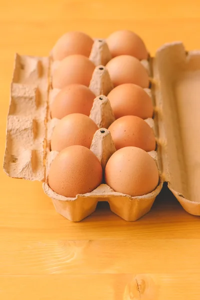 Ten chicken eggs in cardboard box — Stock Photo, Image