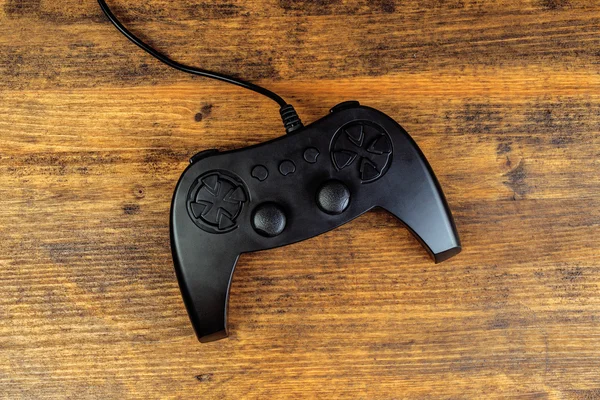 Game pad controller on wooden desk, flat lay top view — Stock Photo, Image