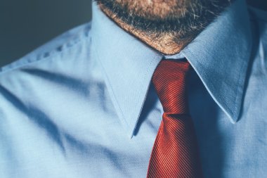 Bearded businessman in blue shirt and red necktie clipart