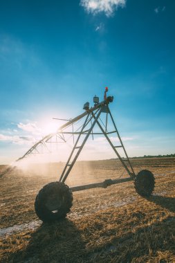 Center pivot irrigation system with drop sprinklers in field clipart