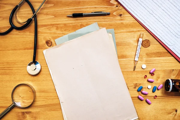 Doctor's work desk, General medical practitioner workspace, top — Stock Photo, Image