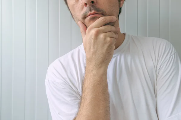 Man with hand on chin thinking deep thoughts — Stock Photo, Image