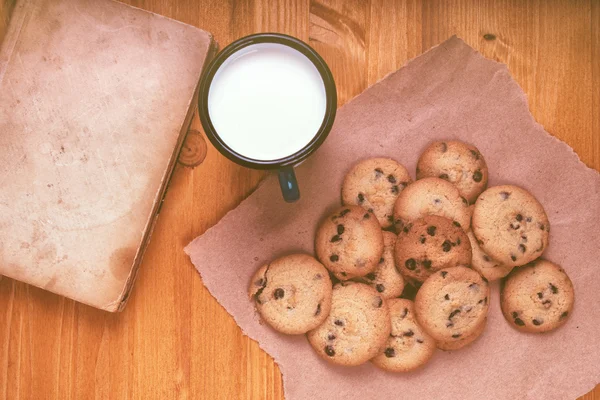 Biscuits aux pépites de chocolat maison, tasse de lait et livre vintage — Photo