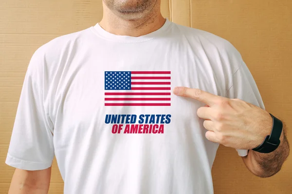 Handsome man proudly wearing white shirt with USA flag — Stock Photo, Image