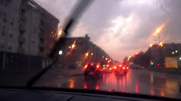Driving through city streets on rainy evening — Stock Video