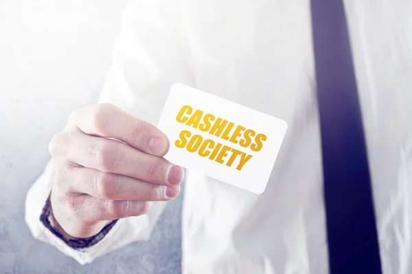 Businessman holding card with Cashless society title — Stock Photo, Image