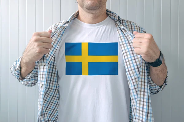 Muž na sobě bílou košili s vlajka Švédsko tisku — Stock fotografie