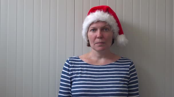 Женщина в рождественской шляпе Санта Клауса показывает средний палец — стоковое видео