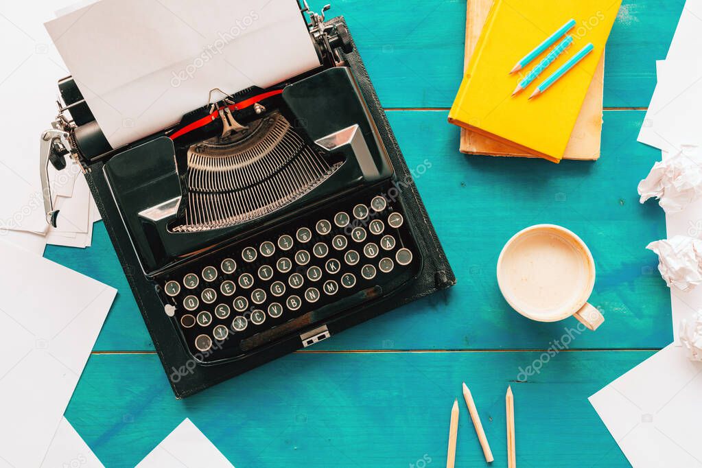 Top view of writer's block concept with vintage classic typewriter on author's desk, copy space included