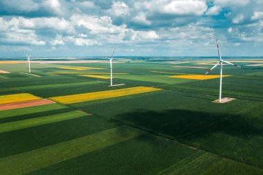 Aerial view of wind turbines on modern wind farm from drone pov, high angle view of innovative sustainable resources technology clipart