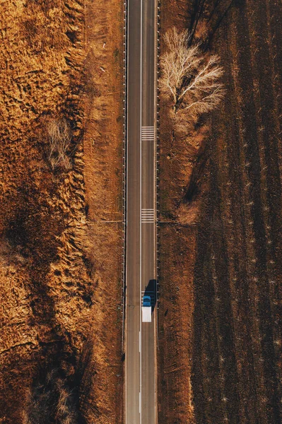 Mini truck on the road from above, drone pov aerial photography