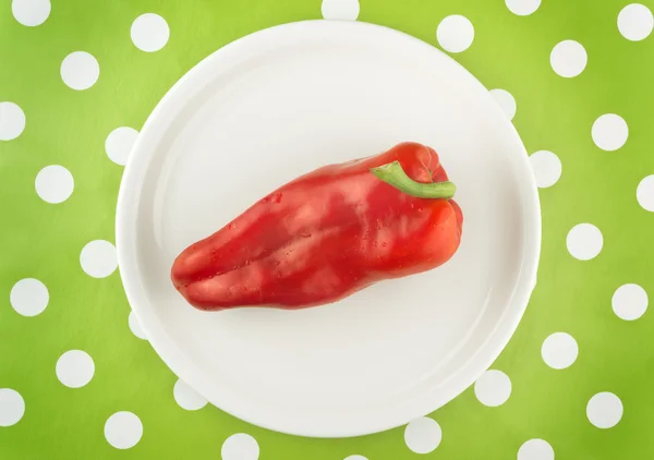 Red pepper on white plate, top view — Stock Photo, Image