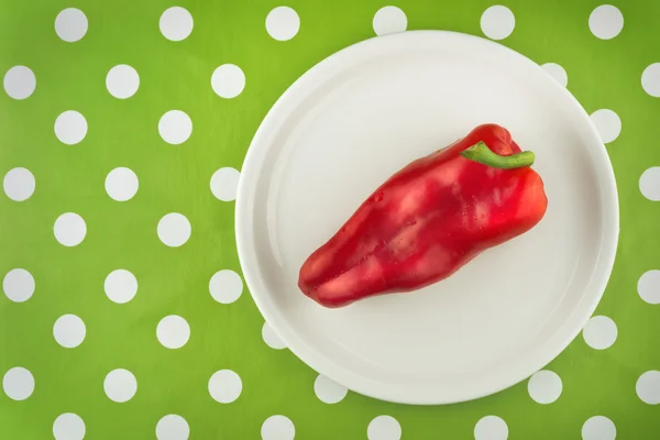 Red pepper on white plate, top view — Stock Photo, Image