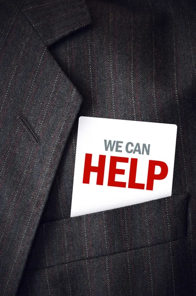 We Can Help business card in suit pocket — Stock Photo, Image