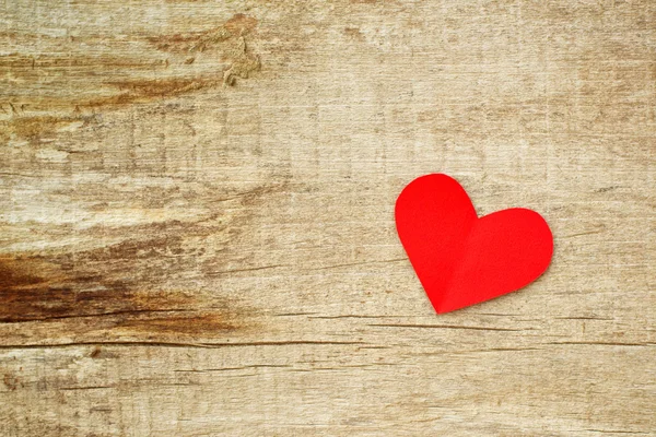 Red paper heart on grunge wooden background — Stock Photo, Image