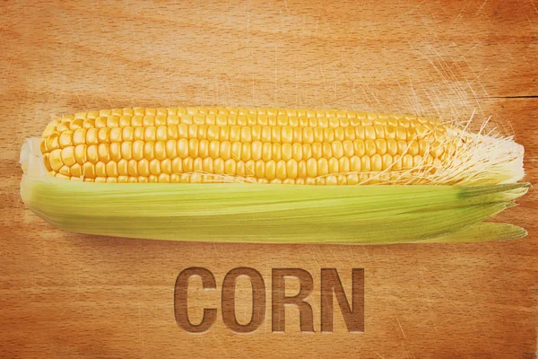 Corn Maize Cob on wooden background — Stock Photo, Image