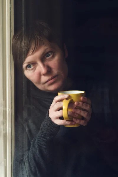 Sad alone Woman Drinking Coffee in Dark Room — Stock Photo, Image