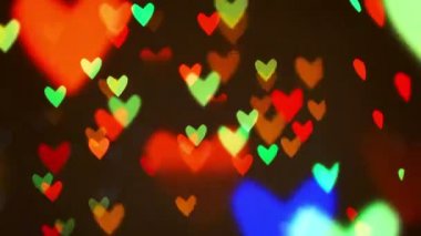 Renkli yanıp sönen kalp bokeh Festival ışık arka plan defocused.